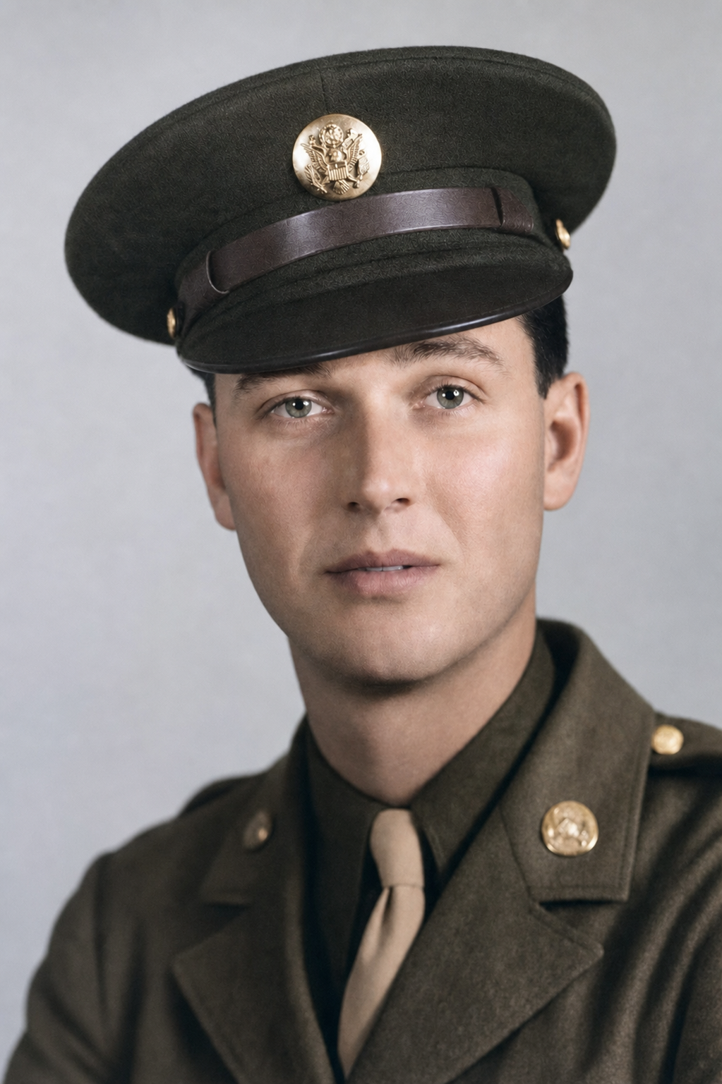 Studio portrait of Corporal Nels J. Bandy in U.S. Army service uniform and visored cap, c. 1944.